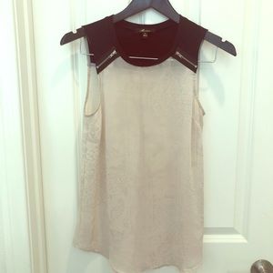 Sleeveless top with zipper detail and sheer bottom